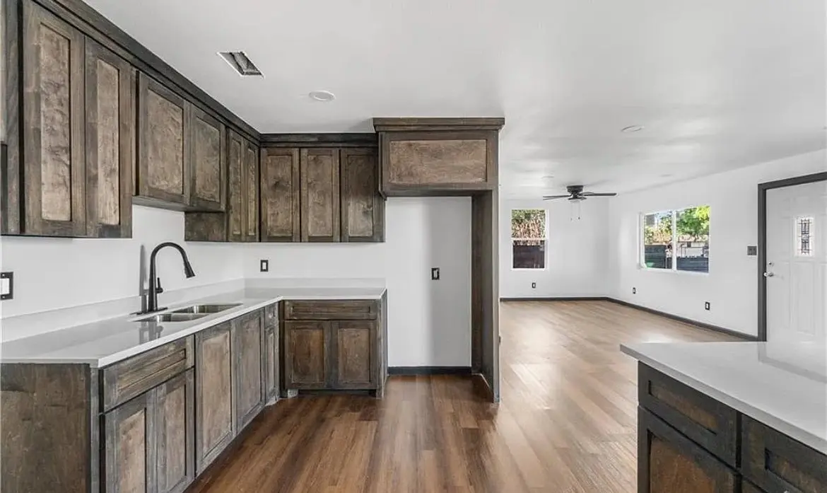 Aguilar crew installing custom cedar pergola accents on a black-clad exterior remodel.